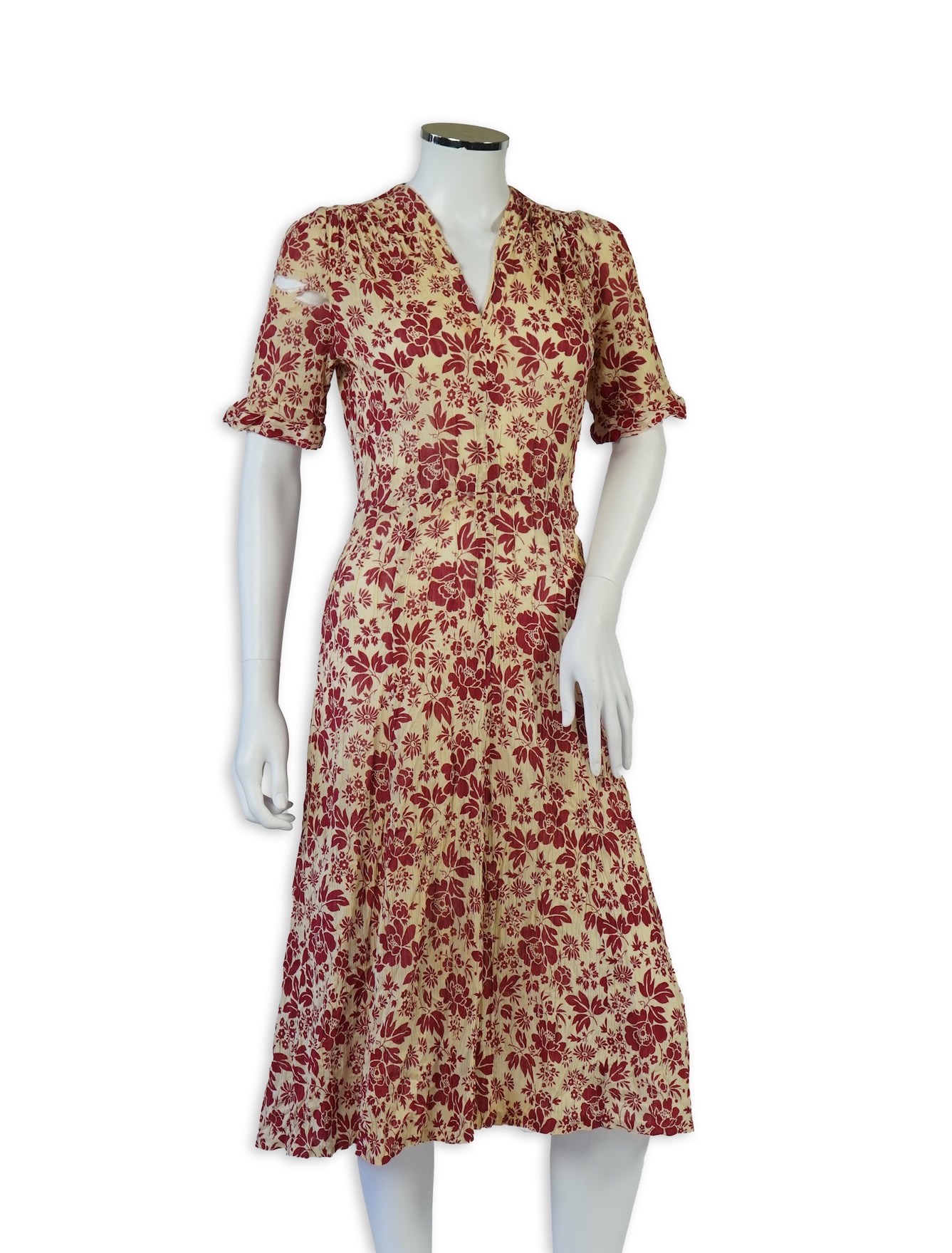 Two 1930's printed silk crepe summer day dresses together with a similar pale blue and black stripped summer day dress., Condition - the maroon and cream dress has damage to one sleeve, the green dress has worn under the